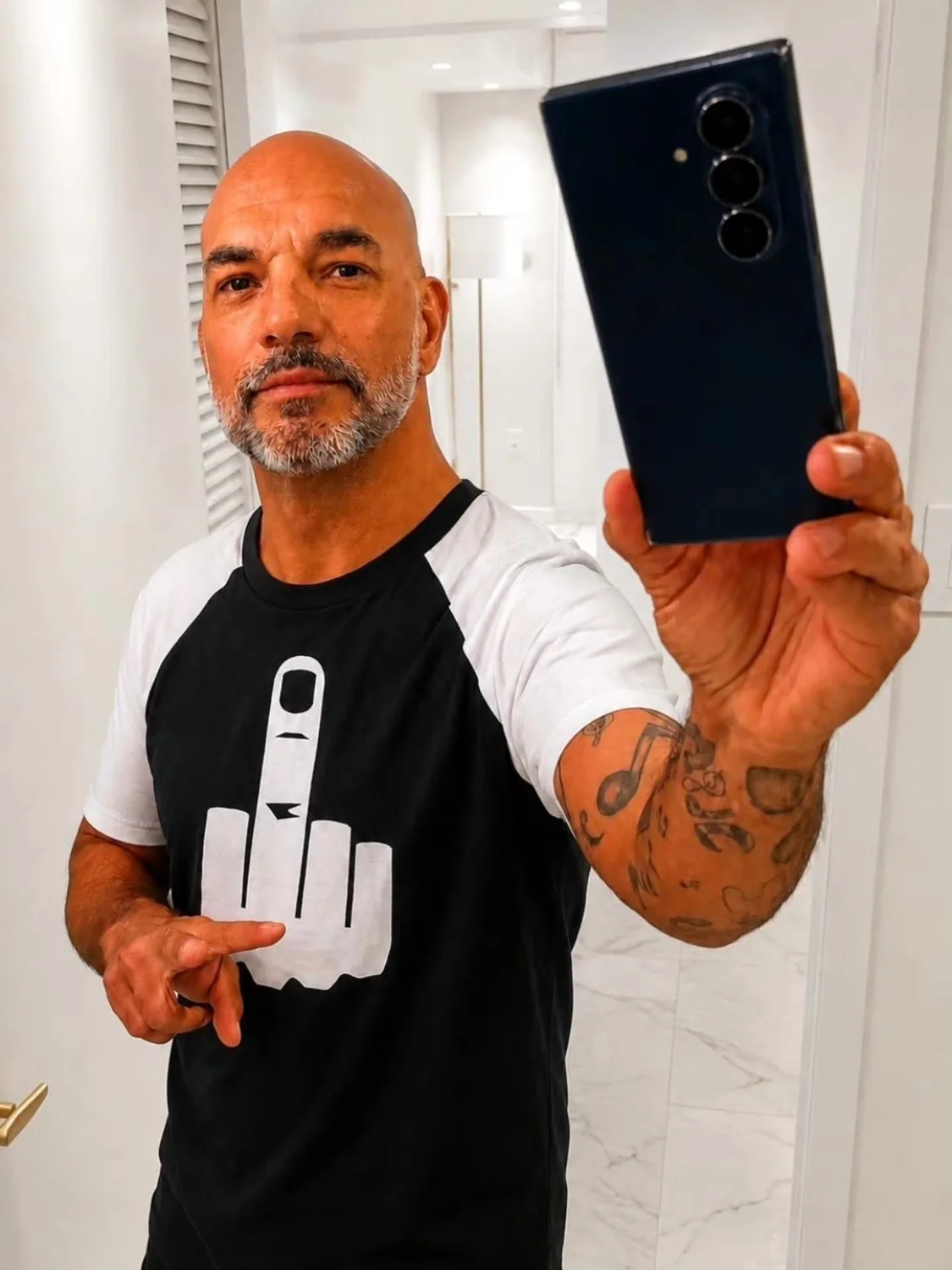 Artist-supplied mirror portrait of AFTER HOUR KAINE in a black-and-white shirt
