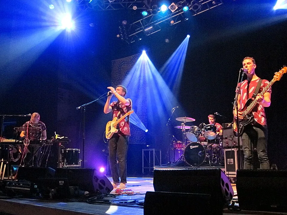 Django Django on stage at Summer Sundae Festival 2012; entire band and performers are visible in the original frame; archival photo of a billed performer at DJANGO DJANGO — DOVELAND TOUR, not this event