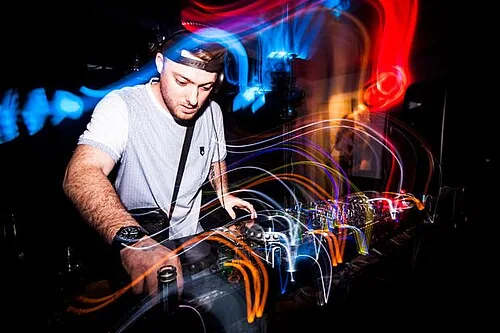 Macky Gee behind the decks in an archival performance photograph; archival photo of a billed performer at UK VS BELGIUM TOUR: MACKY GEE, not this event