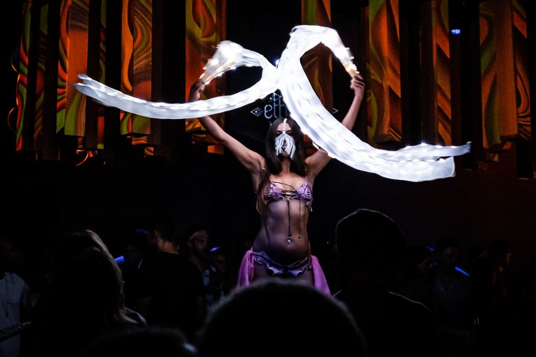 Electronic music performance with colorful stage lighting